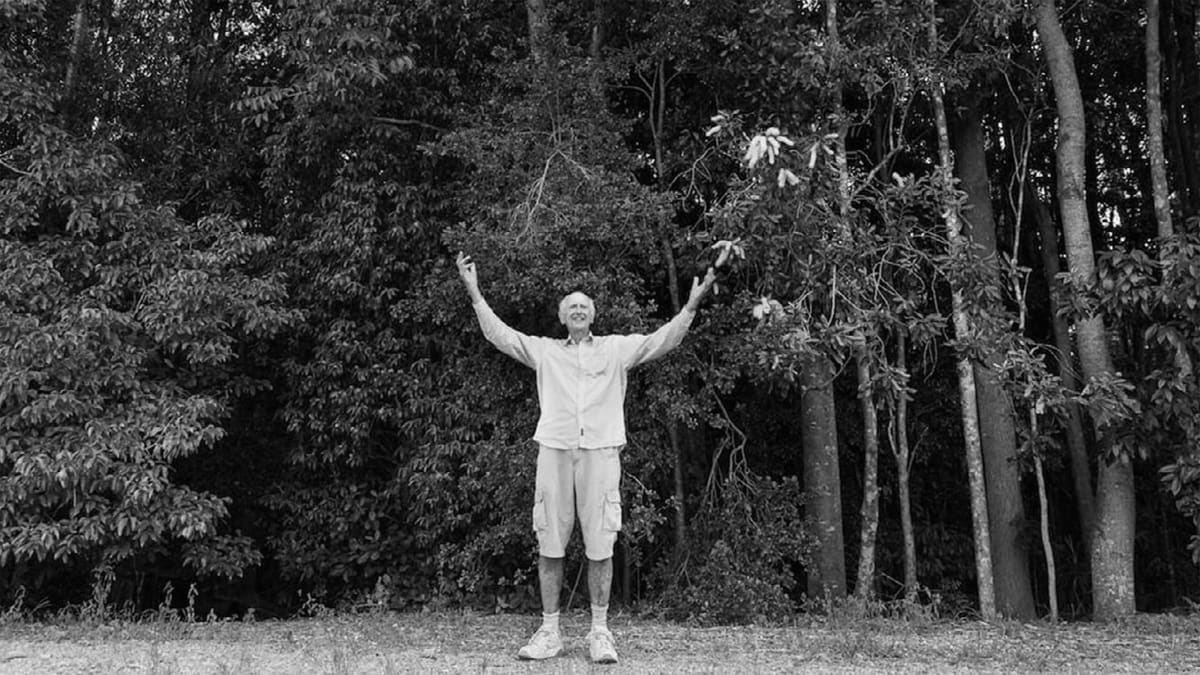 Tony Parkes standing in lush green rainforest he helped restore in northern New South Wales