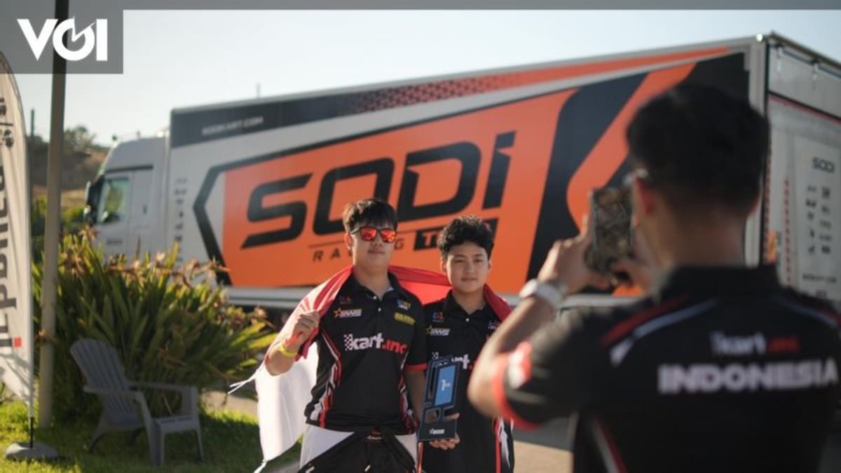 Young Indonesian racer Raphael Anggoman celebrating electric kart racing victory in Sicily Italy