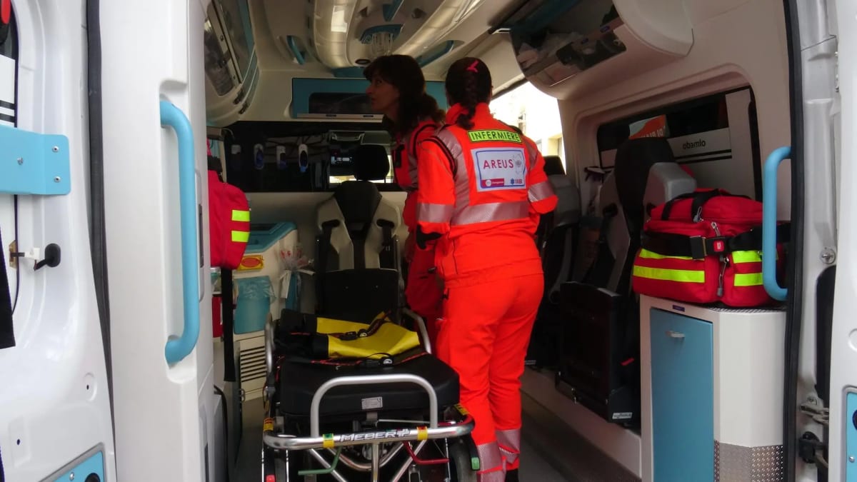 Emergency ambulance nurse checking medical equipment inside vehicle in Sardinia, Italy