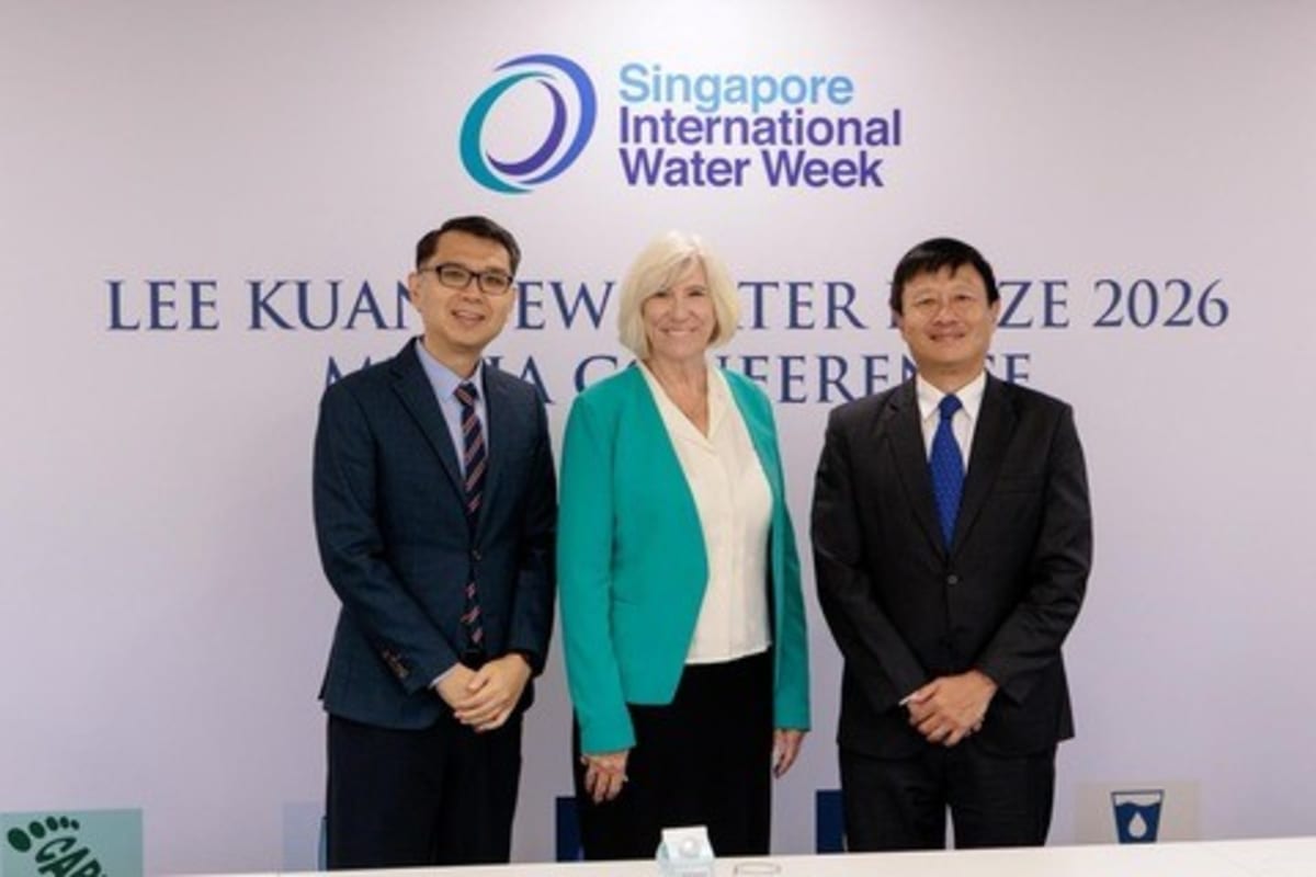 Professor Joan Rose standing with Singapore water officials holding award certificate and smiling