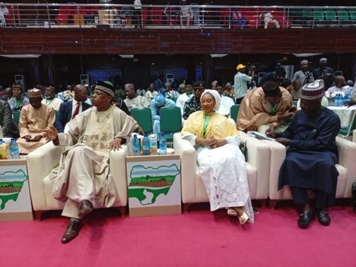 Nigerian farmers working restored fertile land in northern semi-arid region under clear sky