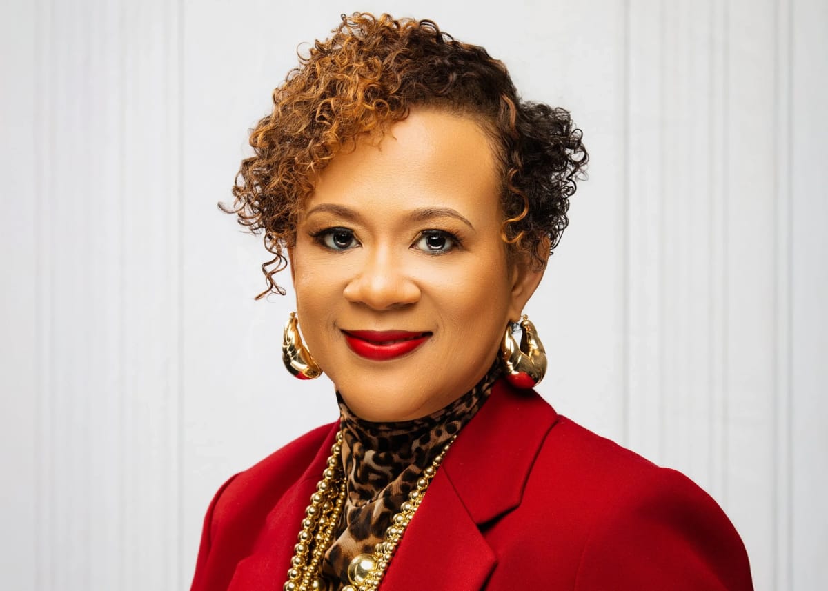 Alicia Johnson smiling at Georgia Public Service Commission office building