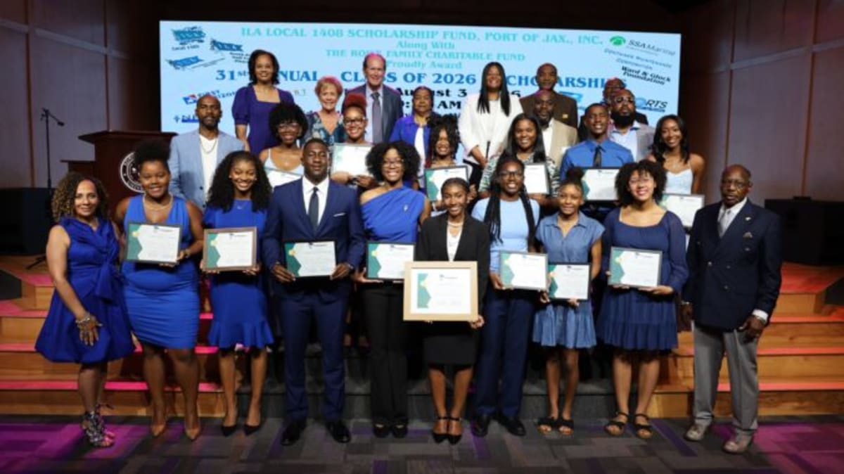 Scholarship recipients pose with longshoremen union leaders at Edward Waters University ceremony