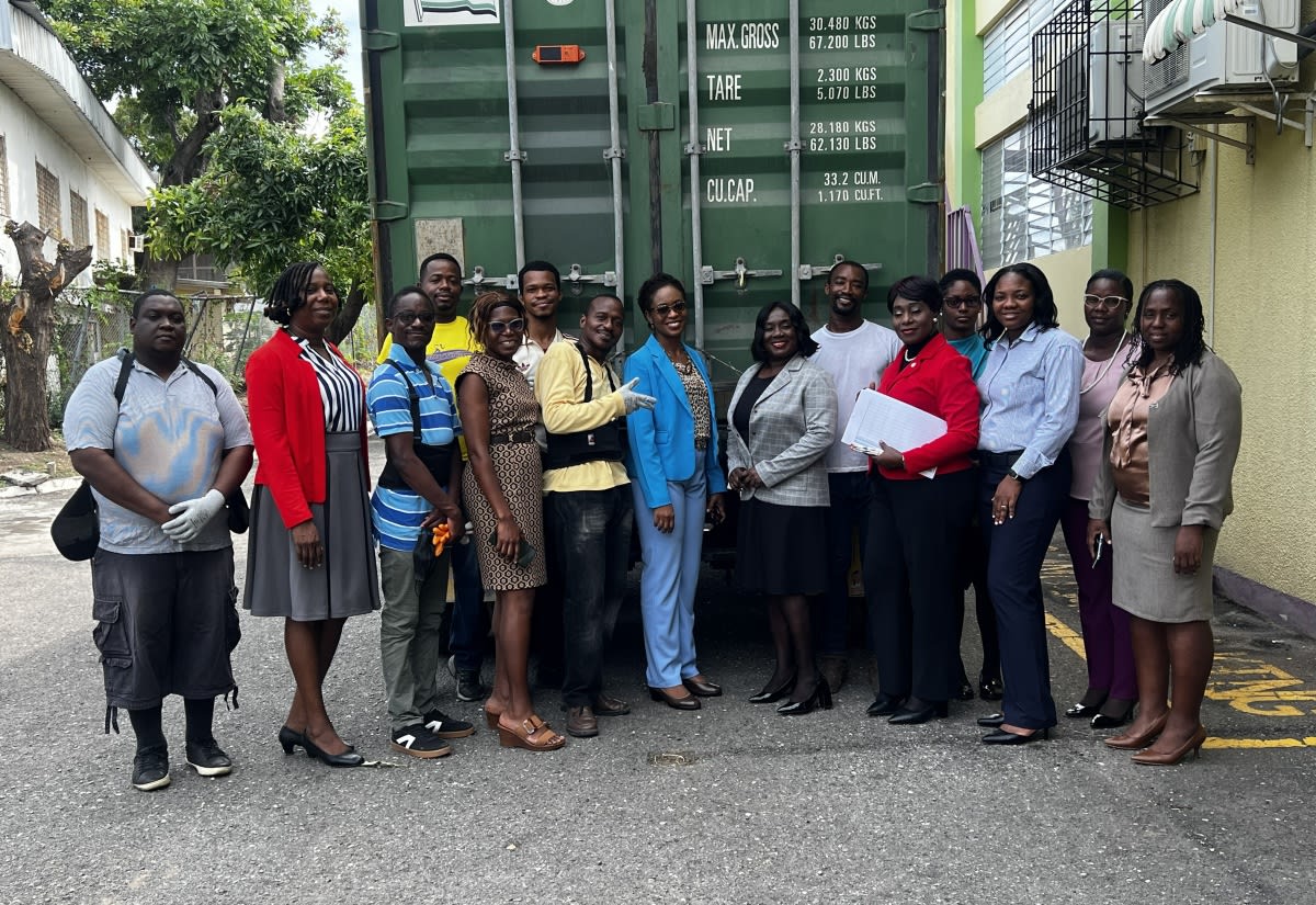 Stacks of brand new donated books being unloaded from shipping container in Jamaica
