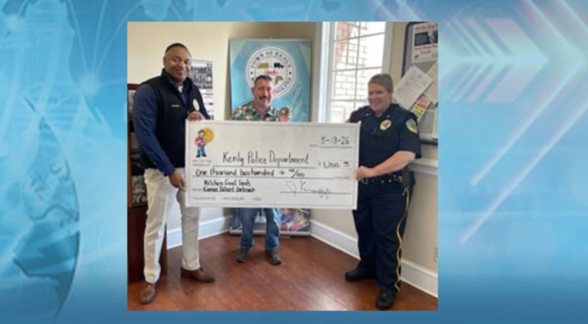 Jason Knapp of Kitchen Goat Feeds presenting donation check to Kenly Police Department
