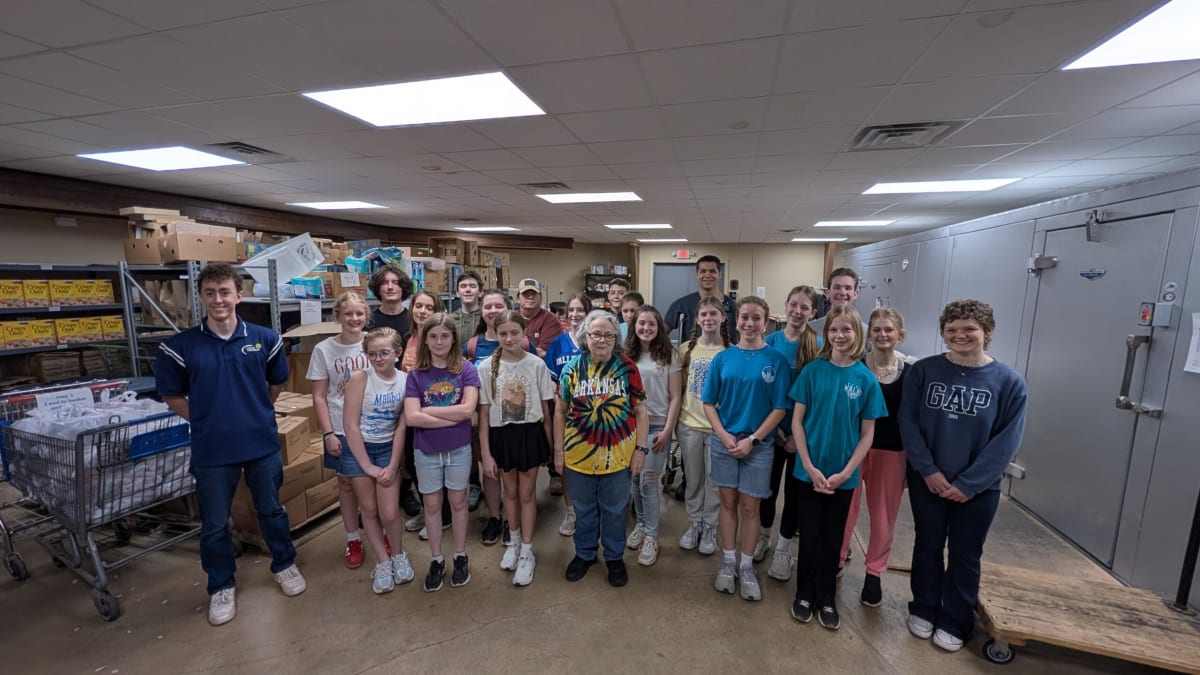 Young volunteers packing food boxes at Helping Neighbors Food Pantry in Jonesboro Arkansas