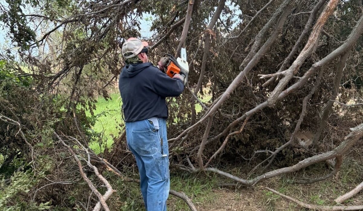 PSO employee Russell Pitts helping clear tornado debris in Enid neighborhood damaged by April storm