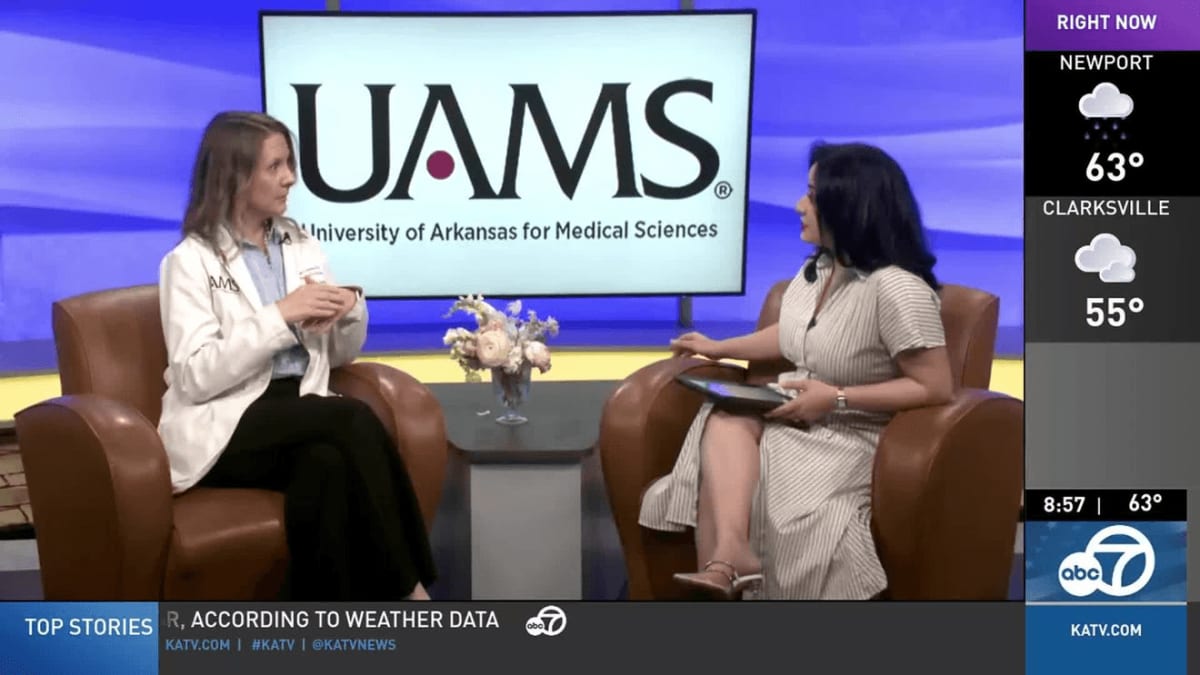 Medical professional preparing patient for SAINT brain stimulation therapy session at UAMS facility