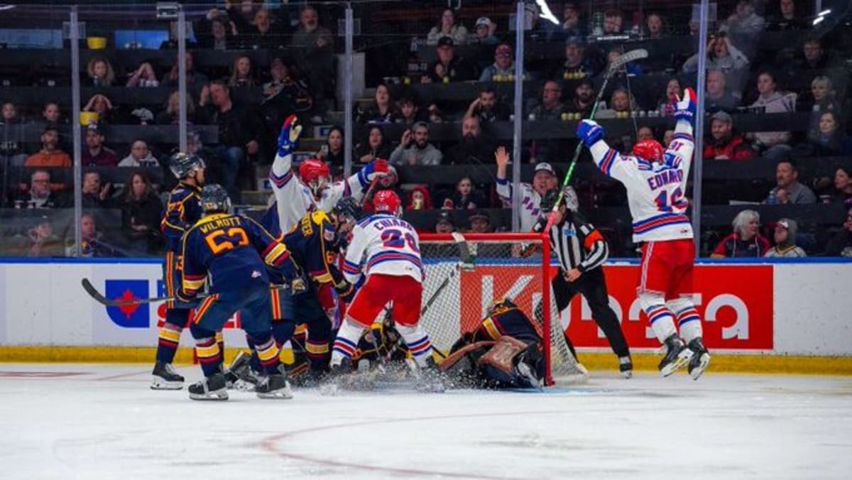 Kitchener Rangers hockey players celebrating with OHL Championship trophy after historic series sweep