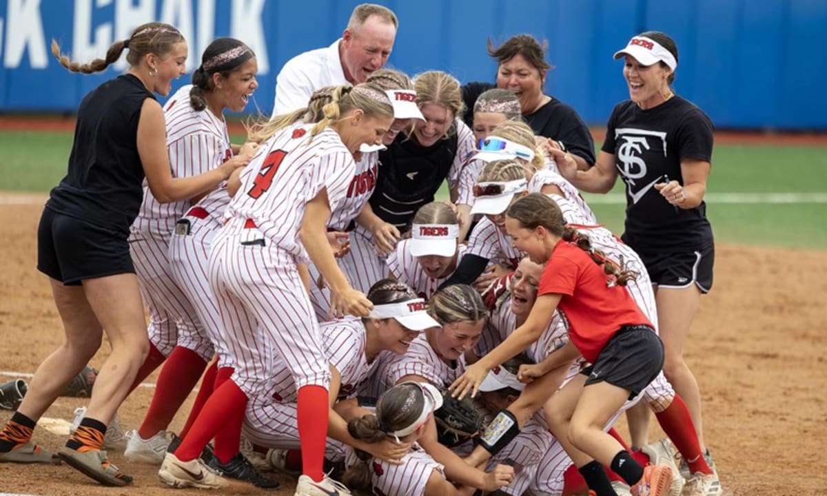 Fort Scott Tigers softball team celebrates with championship trophy after defeating Wamego