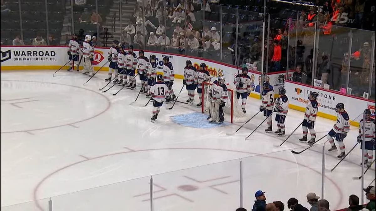 Hibbing Chisholm Bluejackets hockey players celebrating on ice after semifinal victory