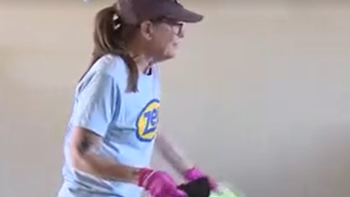 Volunteers cleaning an apartment to help elderly woman prepare for move to accessible housing