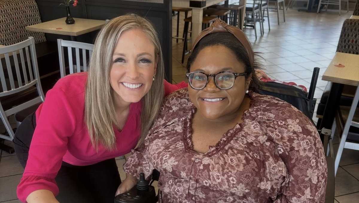 Wilma Brown smiling while working at Chick-fil-A register from her wheelchair in McCalla Alabama