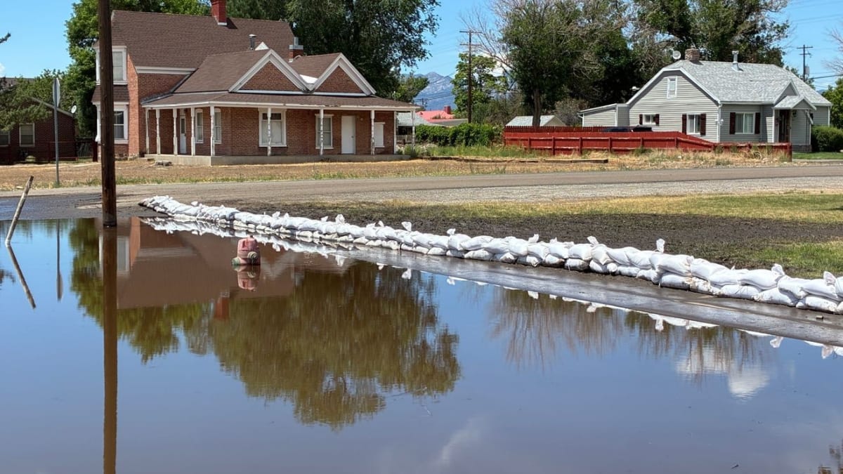 Volunteers clearing mud and flood debris from damaged homes in Beaver Utah's Grove neighborhood