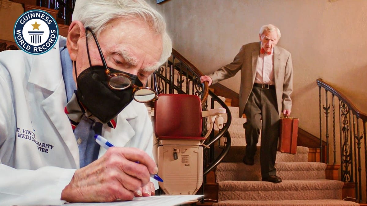 Dr. Howard Tucker, smiling elderly physician in white coat, world's oldest practicing doctor at 103