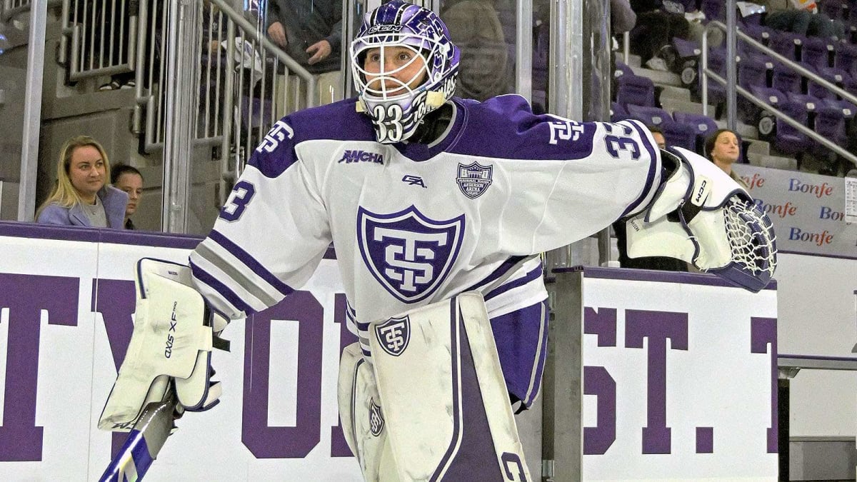 Maggie Malecha, former St. Thomas goaltender and youth hockey program founder, smiling in team gear