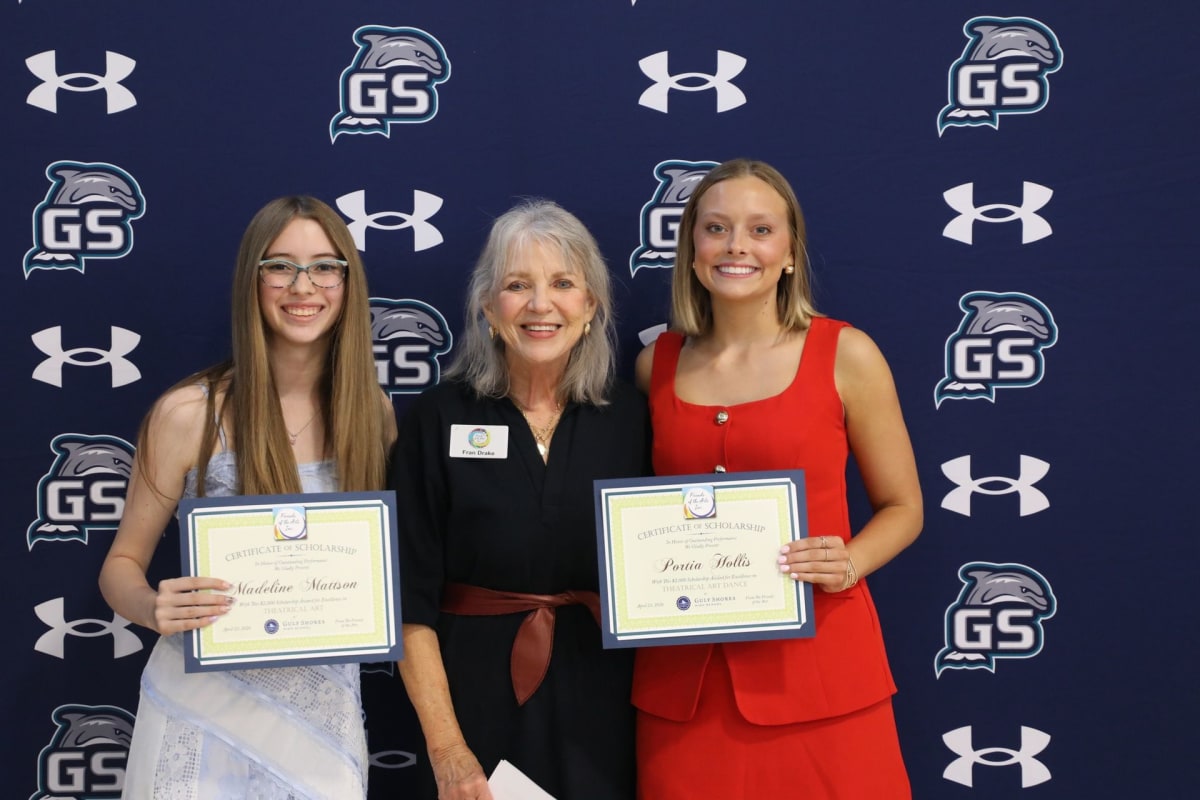 Three high school graduates holding scholarship awards for arts education programs