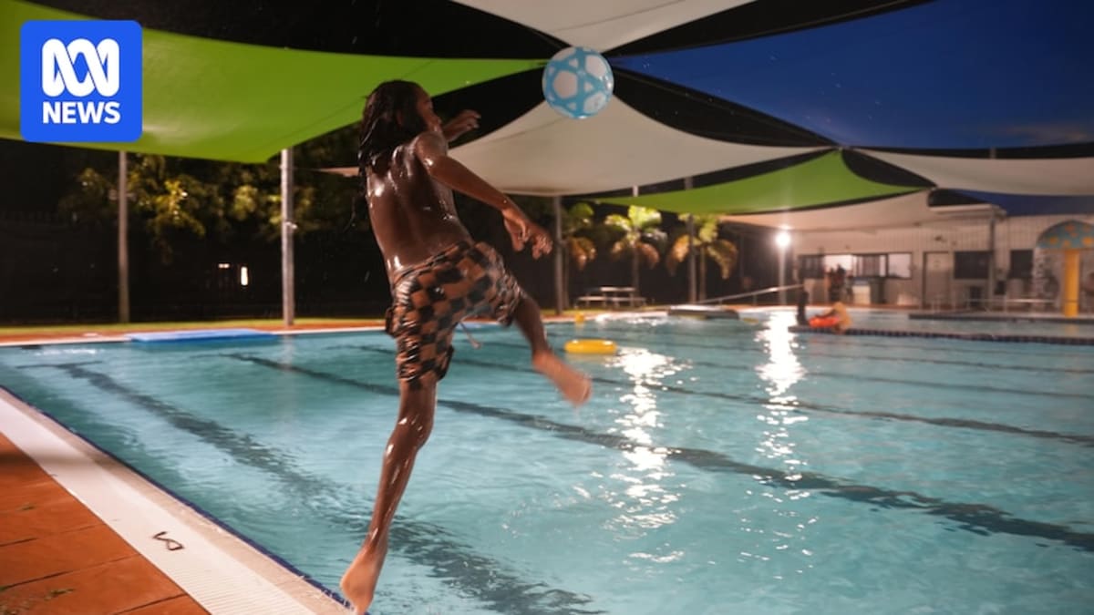Children swimming and playing together in outdoor public pool in remote Australian community