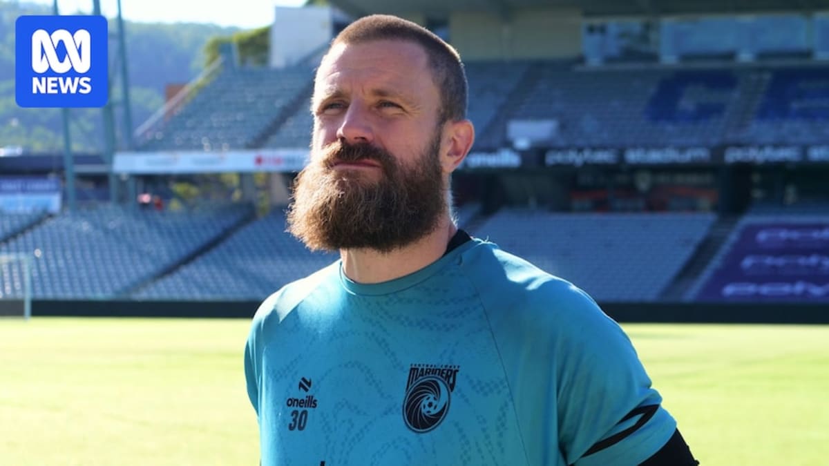 Goalkeeper Andrew Redmayne in his Central Coast Mariners uniform smiling with his signature grey beard