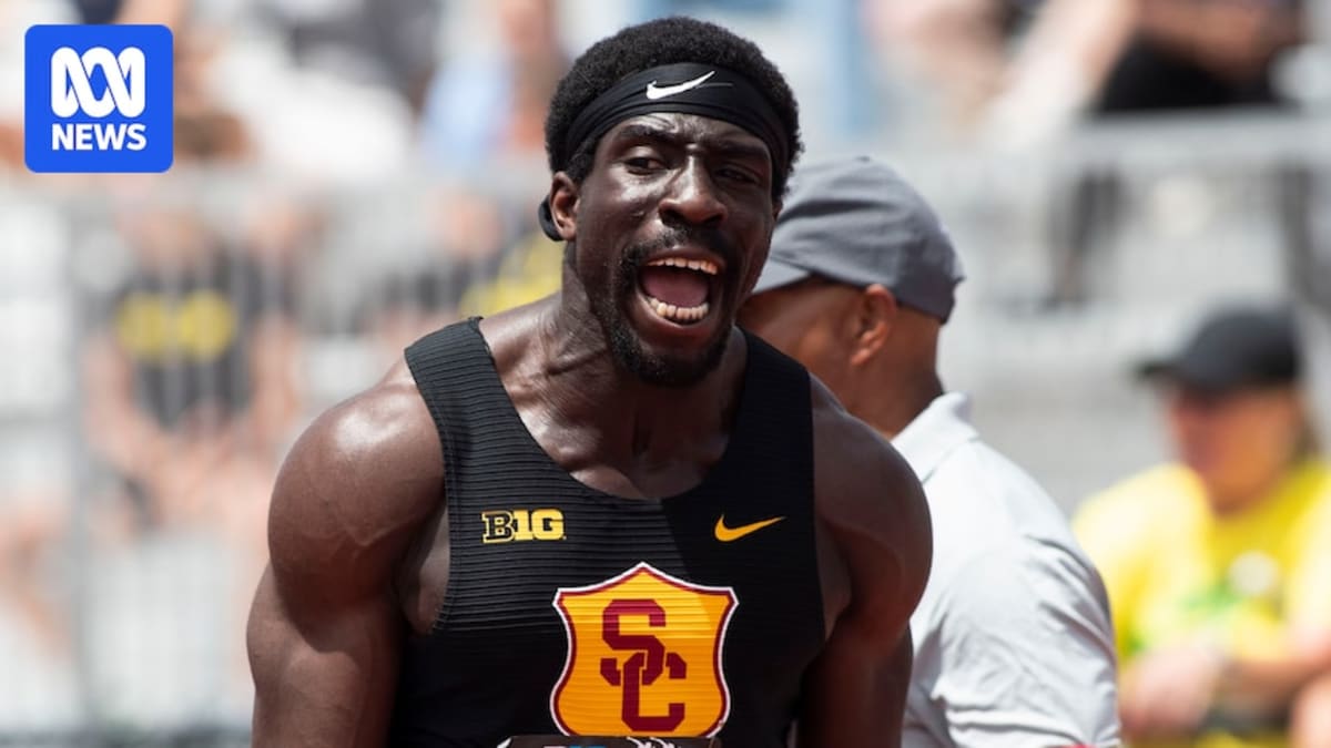 Eddie Nketia sprinting on track during 100 meter race at Big Ten Championships