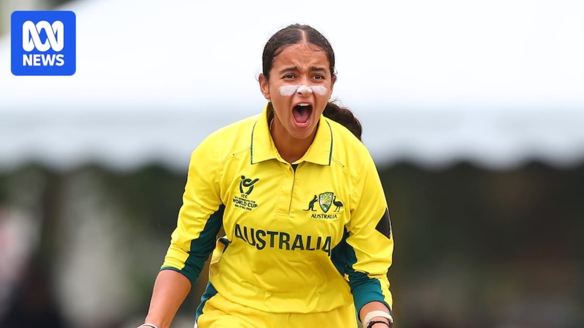 Young cricket player Hasrat Gill in green Australian uniform holding bat on field