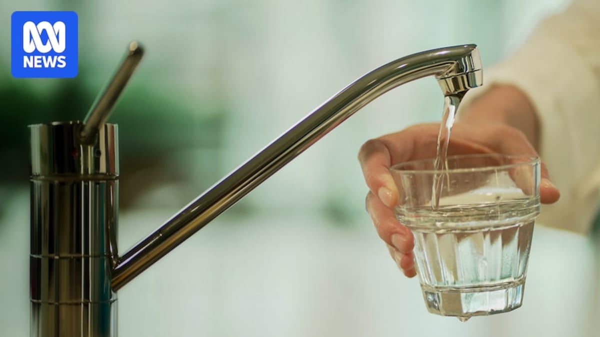 Water flowing from residential tap with Australian coins nearby representing household savings