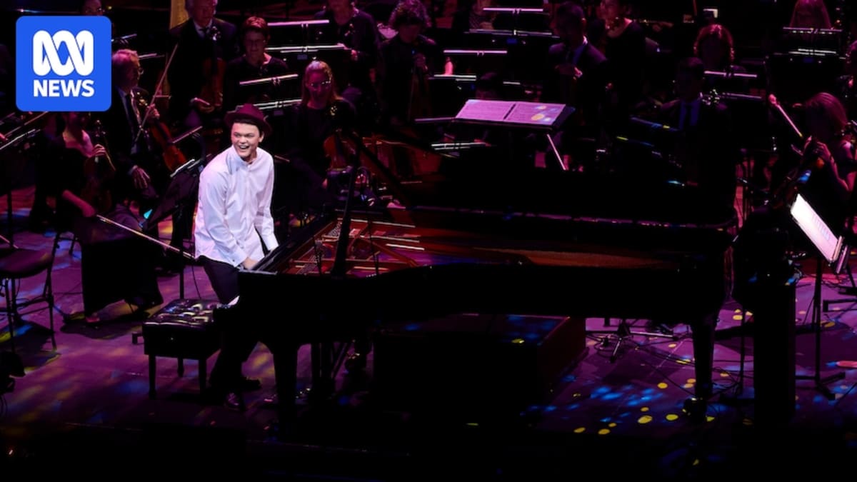 Teenage pianist CJ Jones smiling at camera wearing formal concert attire