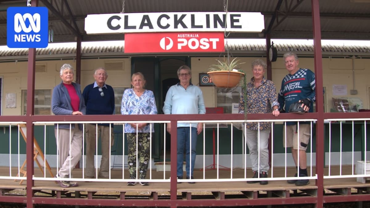 Restored vintage train carriage serving as Clackline's community post office with garden