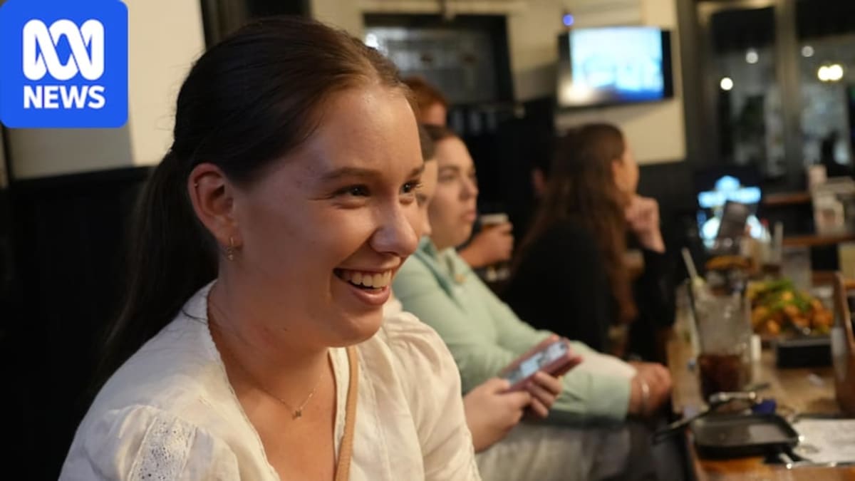 Young agriculture workers smiling and socializing together at networking event in Rockhampton, Queensland