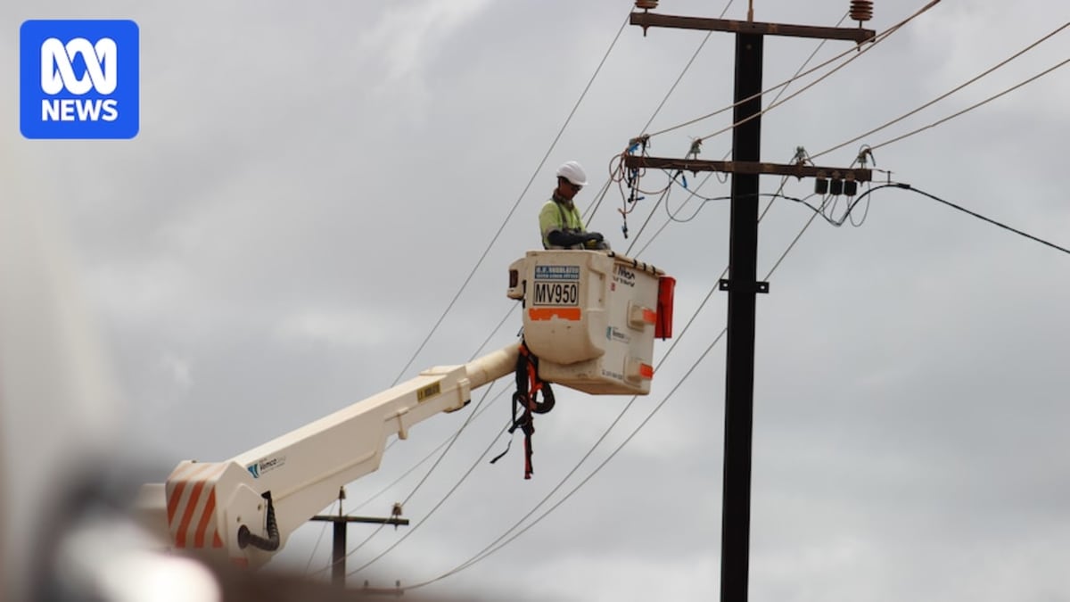 Worker repairing electricity transmission lines in Exmouth, Western Australia after Cyclone Narelle