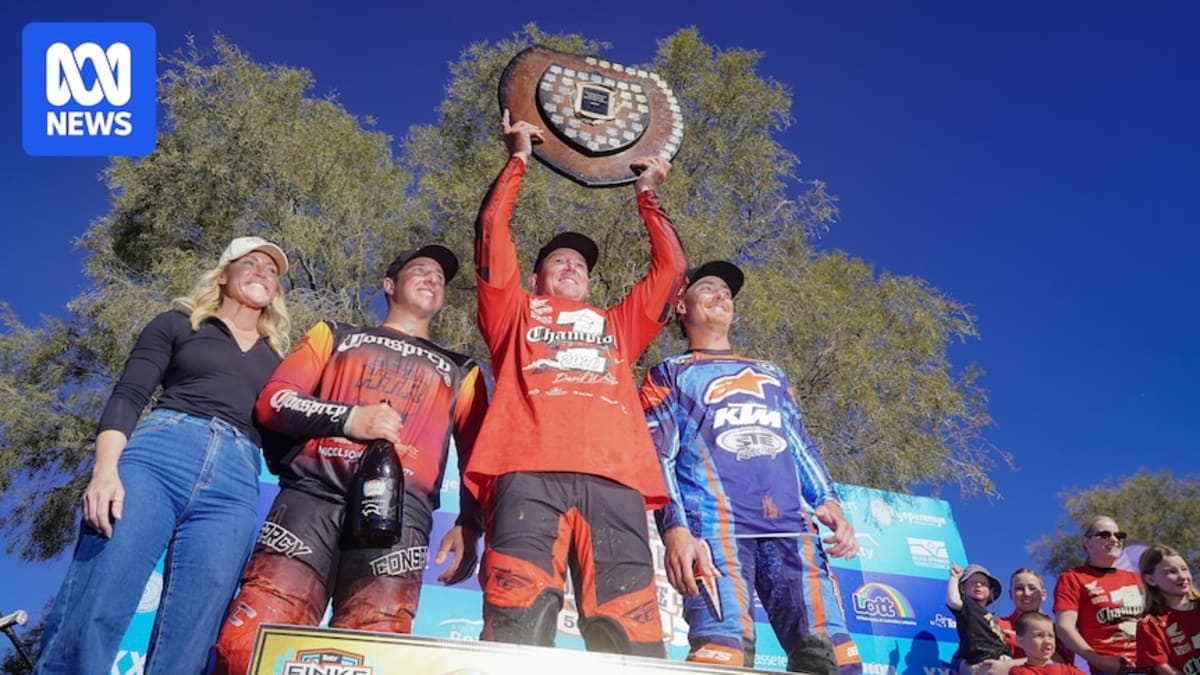 Desert race winner Travis Robinson and navigator Paul Currie celebrating victory with raised arms