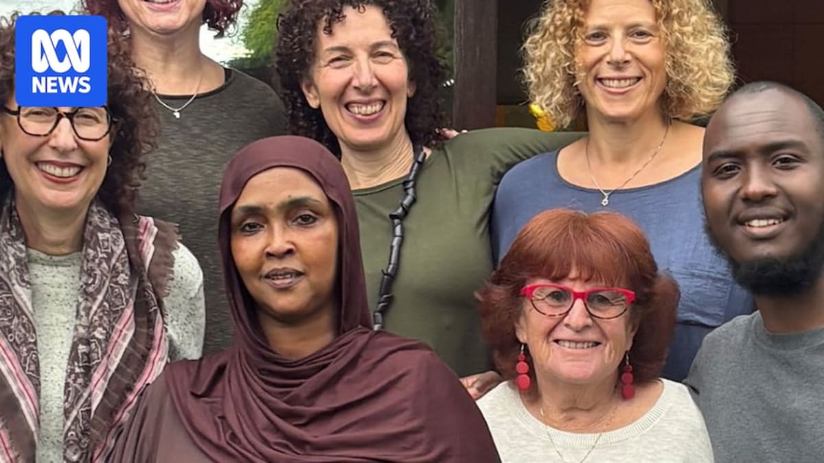 Group of eight friends from Muslim and Jewish backgrounds smiling together in Australia