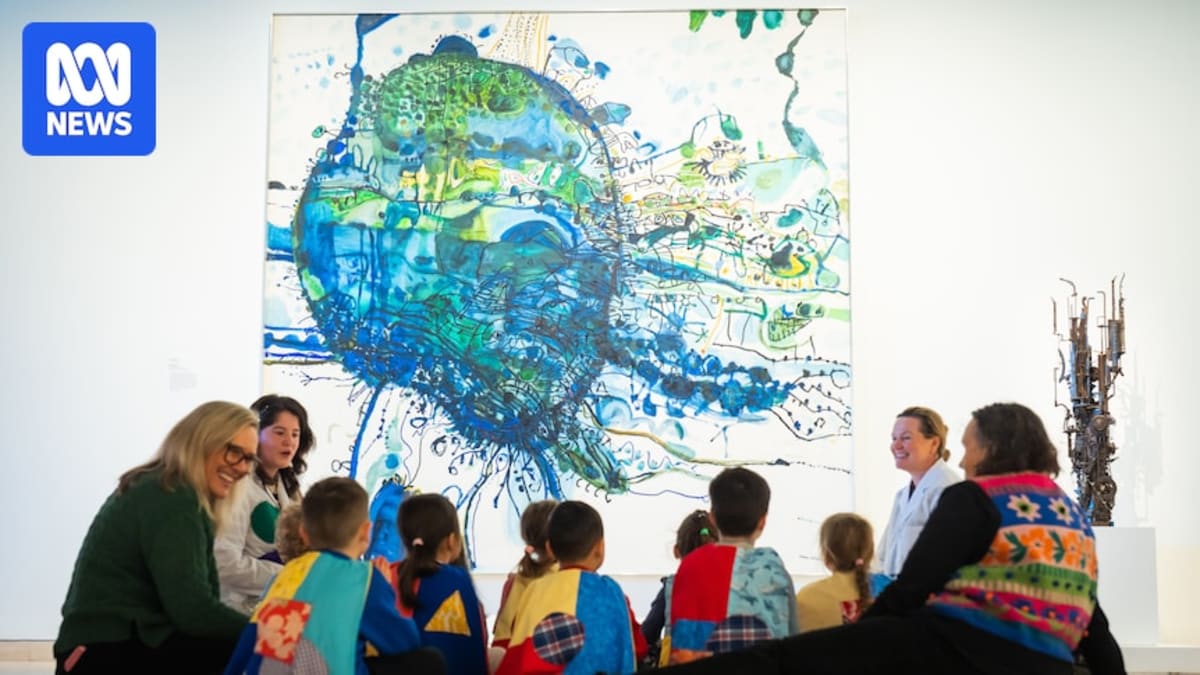 Four-year-old children wearing colorful superhero capes explore paintings at Art Gallery of NSW