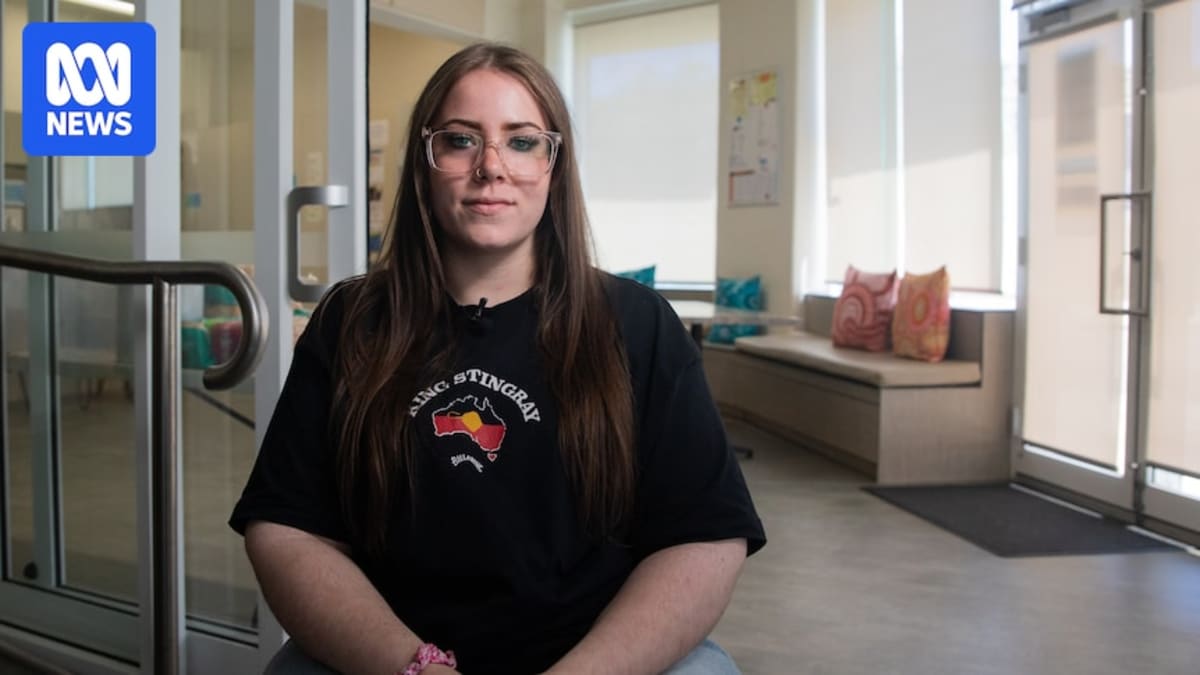 Young person using washing machine at Passages youth homelessness support hub in Perth