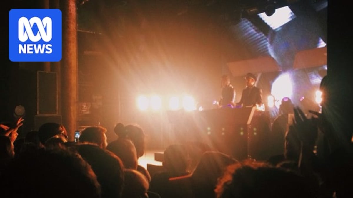 Concert crowd enjoying live music performance at Sydney venue under colorful stage lights