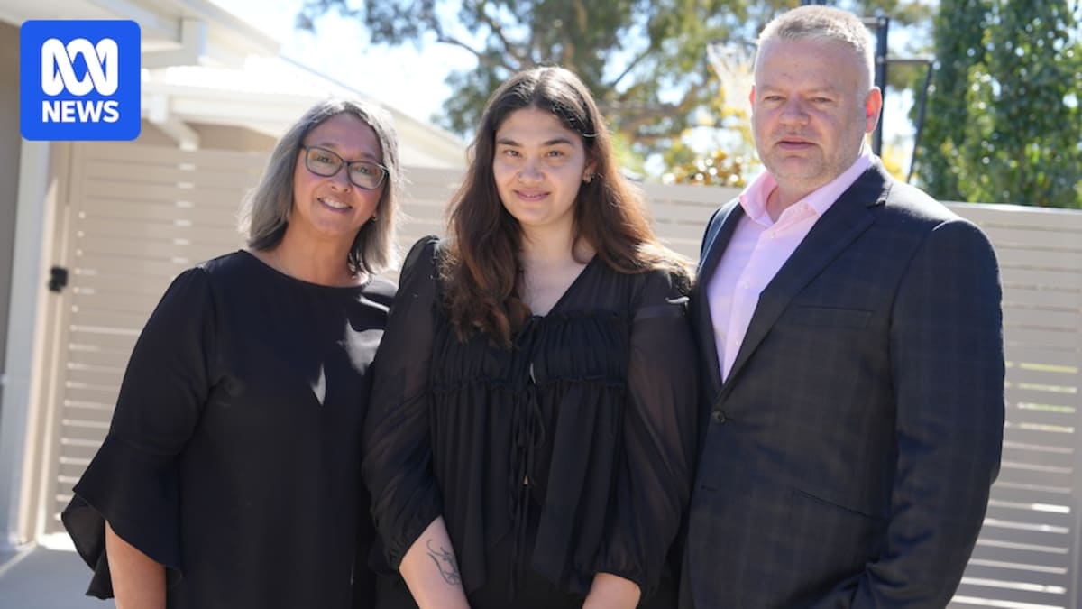Chantelle D'Arcy smiling while holding deed to her new home in Canberra Australia
