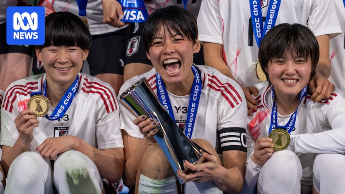 Japanese women's soccer players celebrating together on the field during international competition