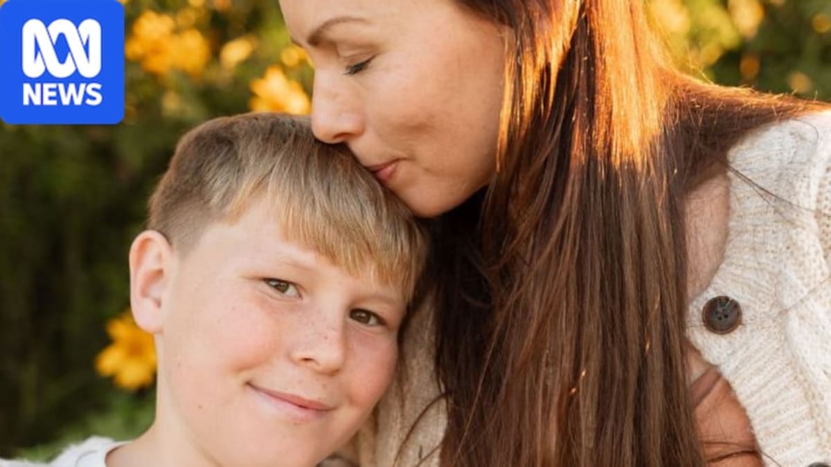 Young boy Cooper Turner smiling outdoors with his family before leukemia diagnosis
