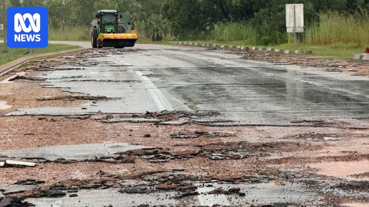 Road repair crew filling potholes on damaged Northern Territory highway after flooding