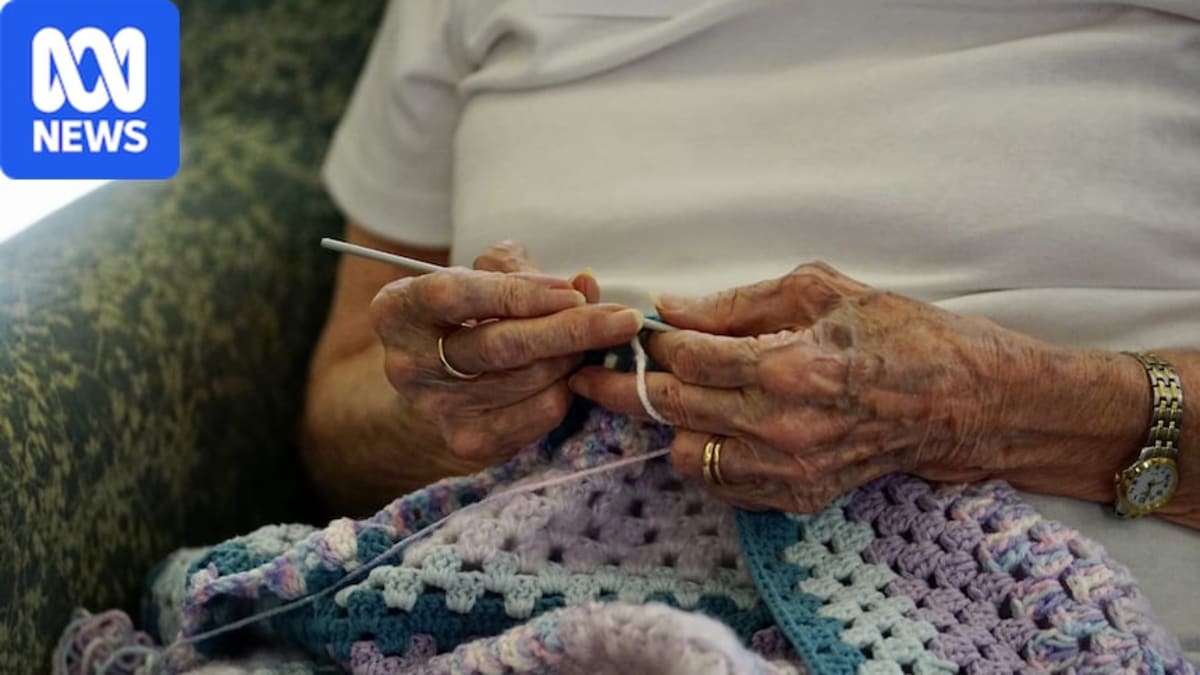 Elderly Australian receiving groceries and support at home from community care worker