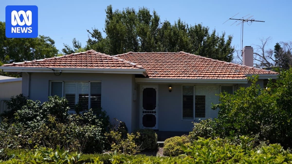 Energy assessor examining older Australian brick home with rating certificate and measurement tools