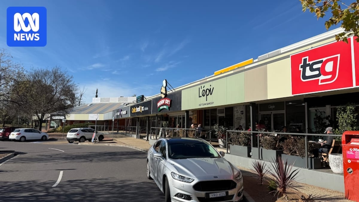 Small local shopping village with bakery and outdoor seating where neighbors gather together