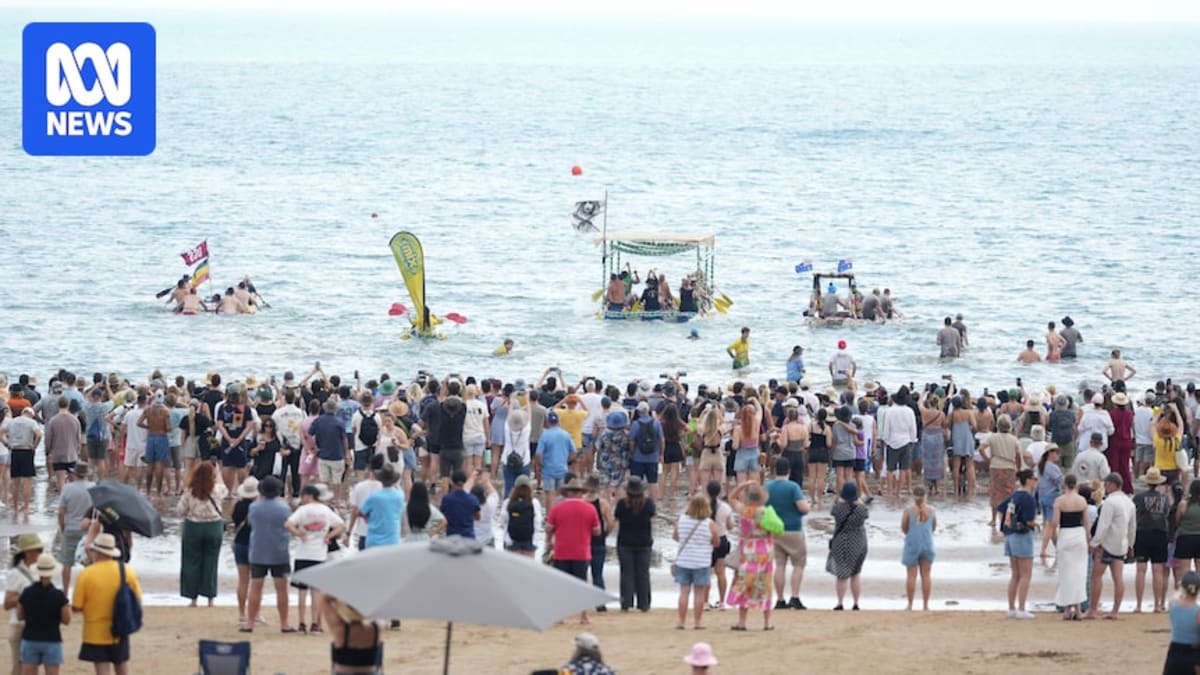 Homemade boats constructed from beer cans racing in shallow water at Darwin's Mindil Beach