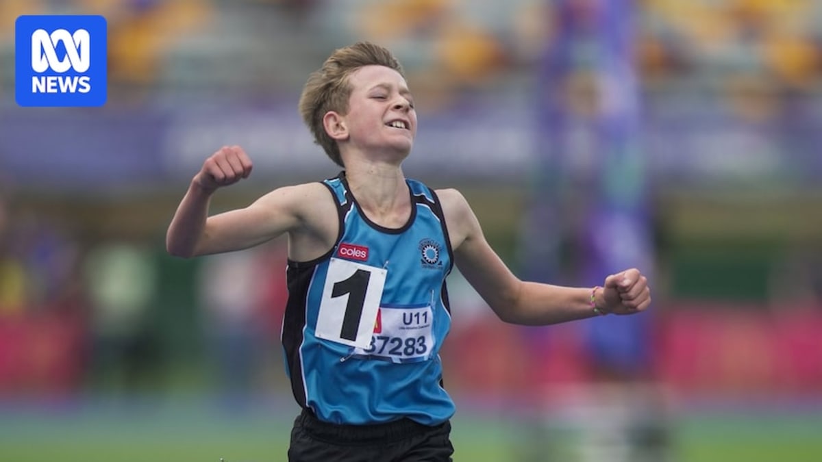 Young runner Rylan Wooster crossing finish line at QSAC Stadium in Brisbane