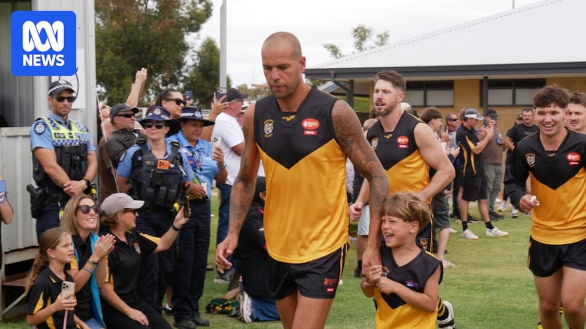 Lance Franklin in Dowerin Tigers jersey running onto football field surrounded by cheering crowd
