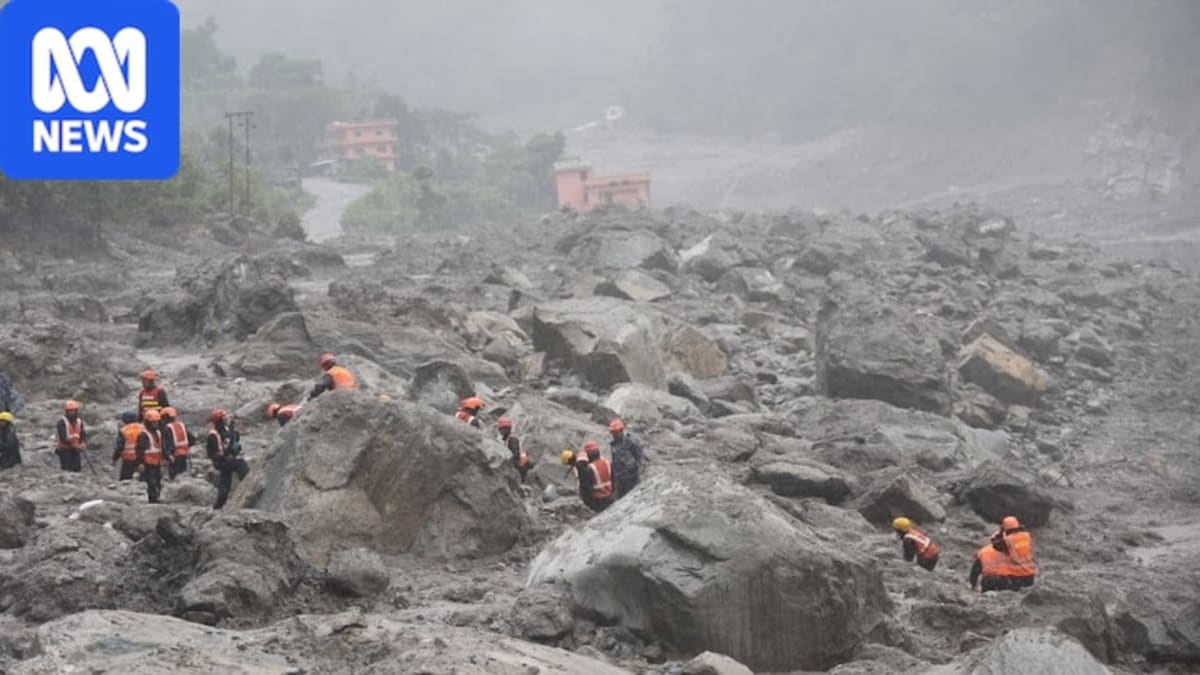 Rescue workers using pumps and generators to clear mud from Nepal hydropower tunnel entrance