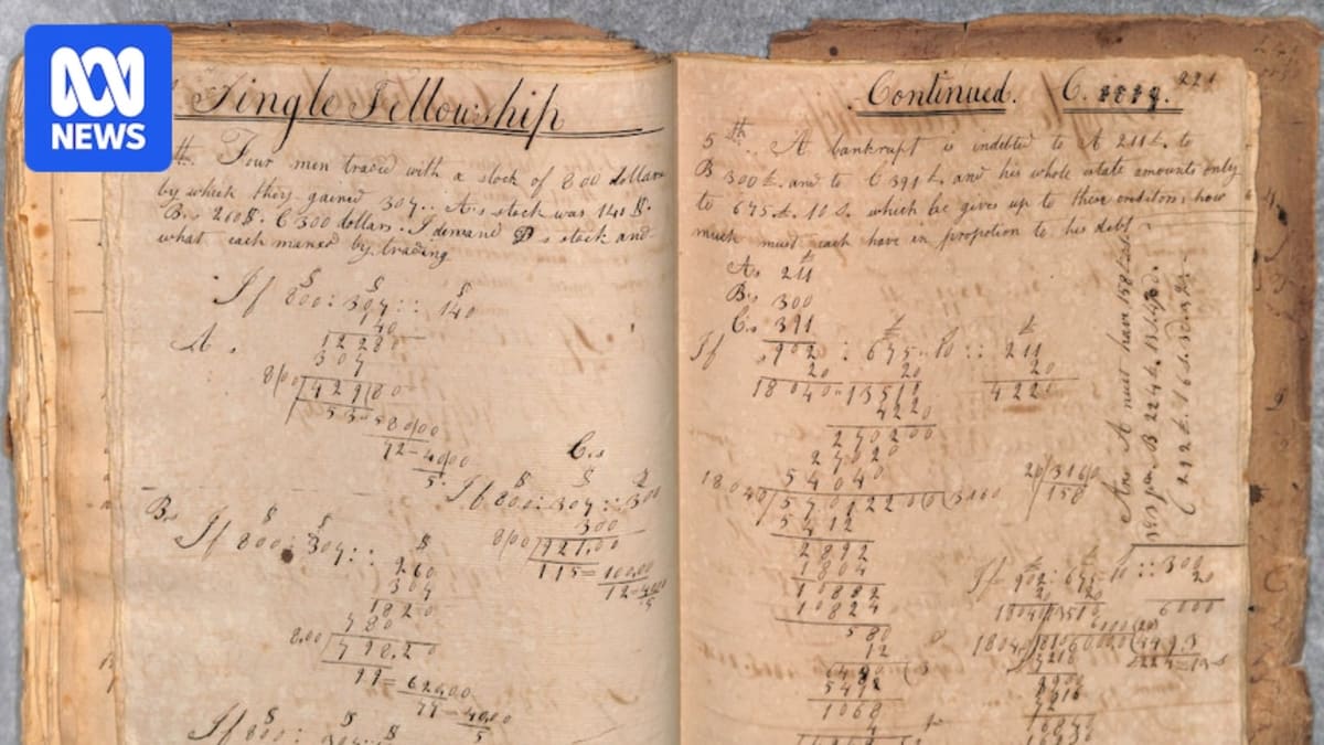 Historic ship logbook and handwritten documents spread on table at Fremantle Prison archives