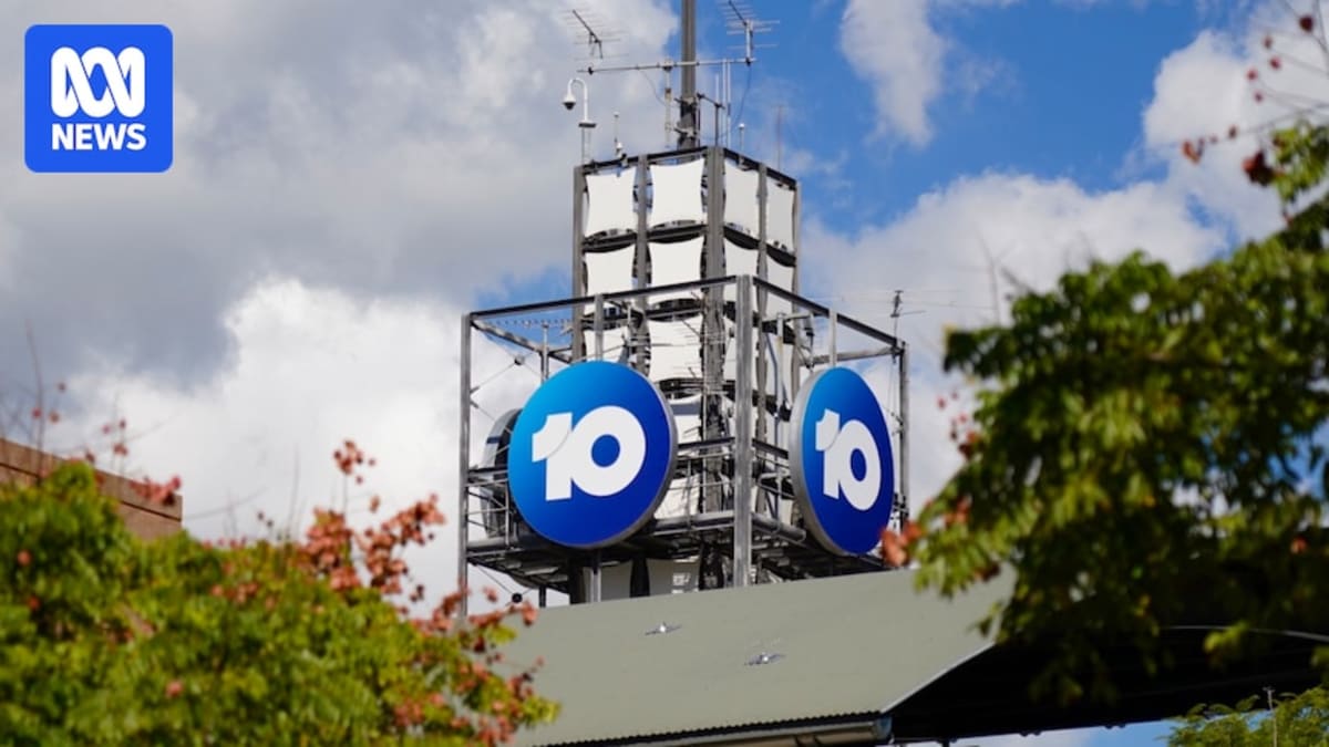 Television broadcast tower standing against clear sky in rural Australian landscape