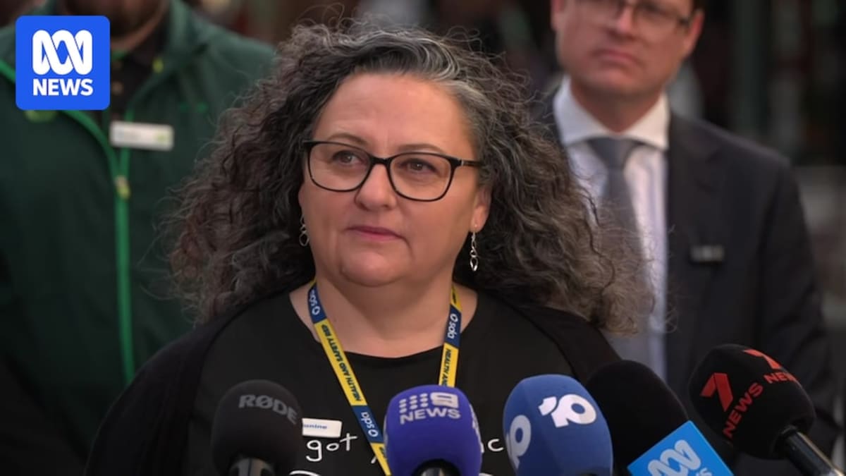 Retail worker standing confidently in store aisle, representing new workplace protections in South Australia