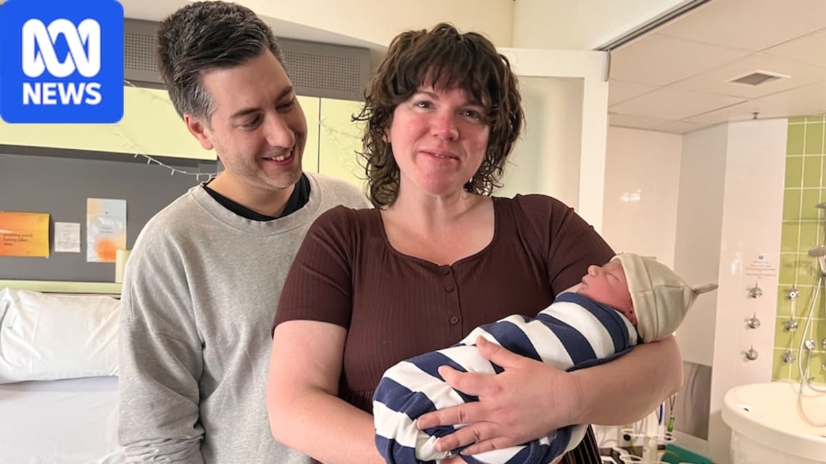 Four smiling midwives in scrubs standing together at Canberra Hospital maternity ward